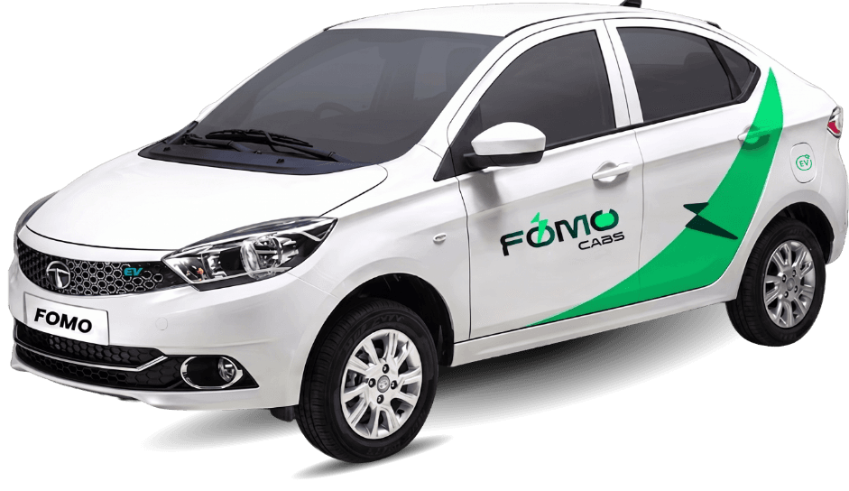 A white FOMO Cabs sedan with green livery